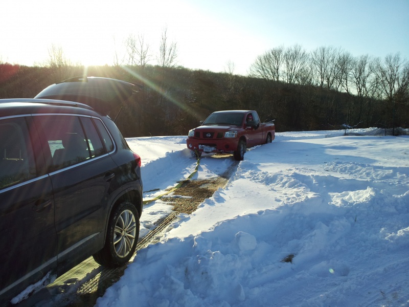 VW Tiguan pulling out a Nissan Titan V8 from the snow
